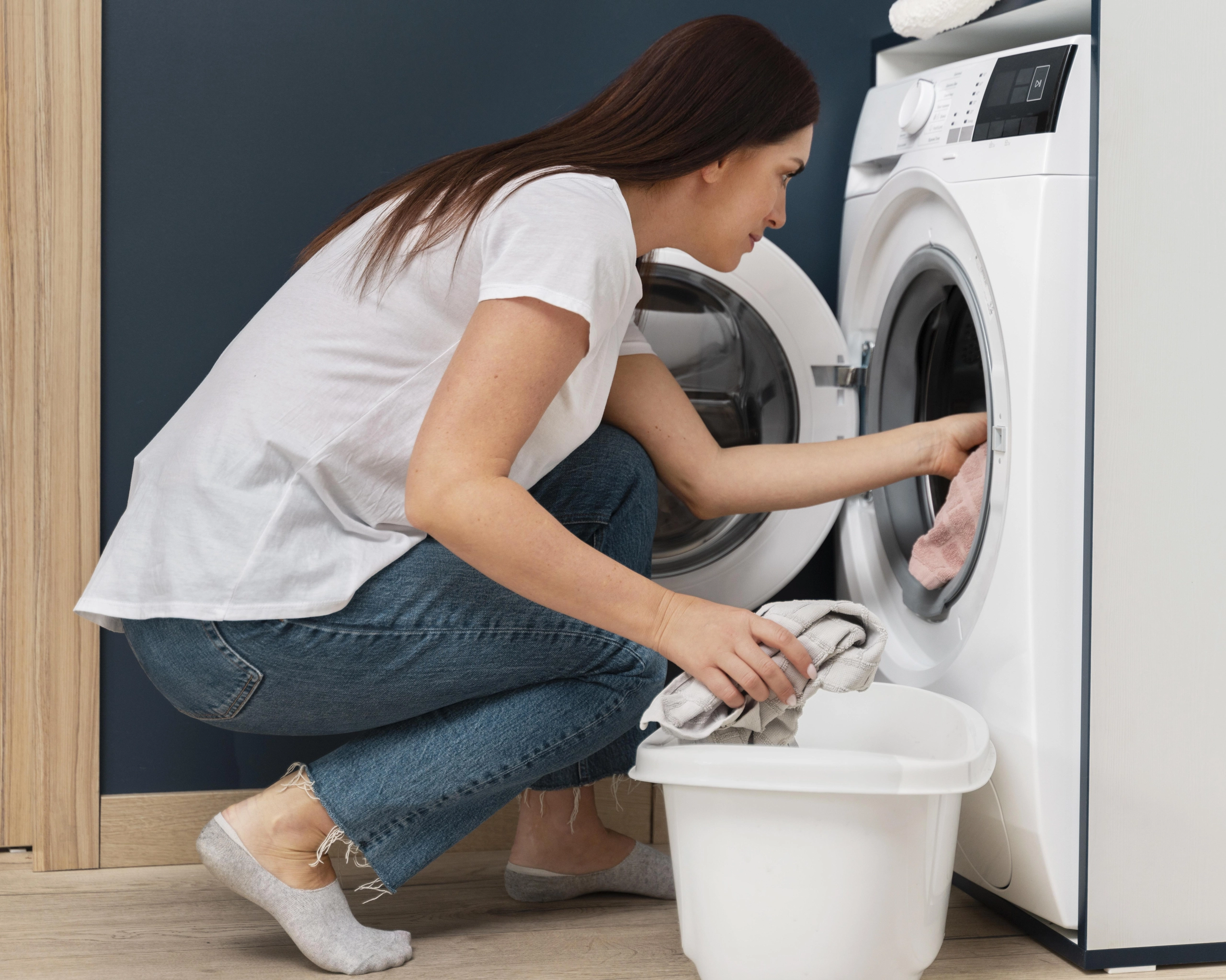 woman-putting-dirty-clothes-washing-machine